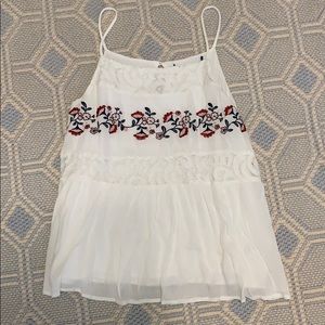 White spaghetti strap top with flower detail